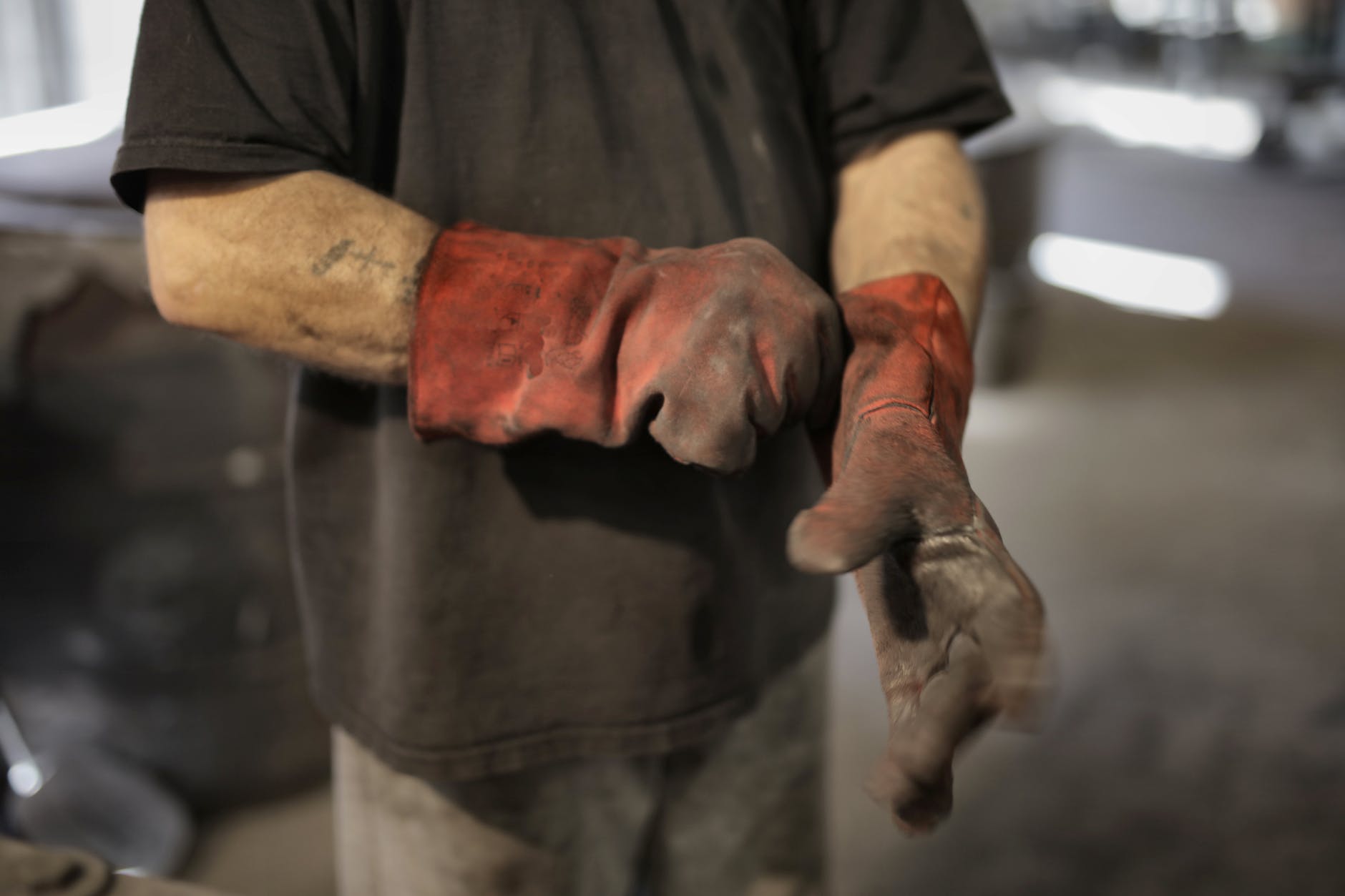 anonymous worker in heavy duty gloves